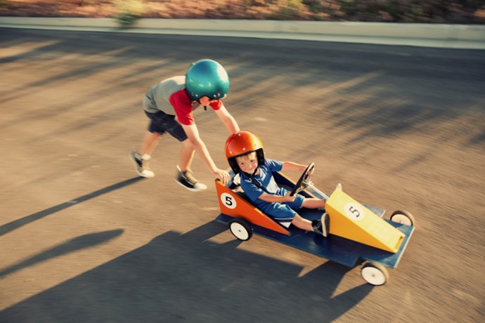 Children playing with push car