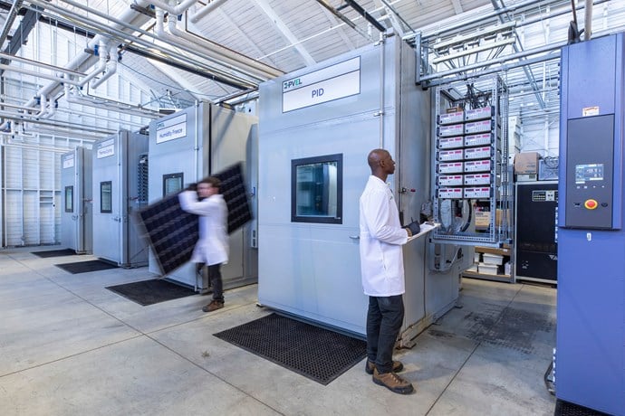 Technicians move modules and monitor chambers at the Kiwa PVEL lab.jpg