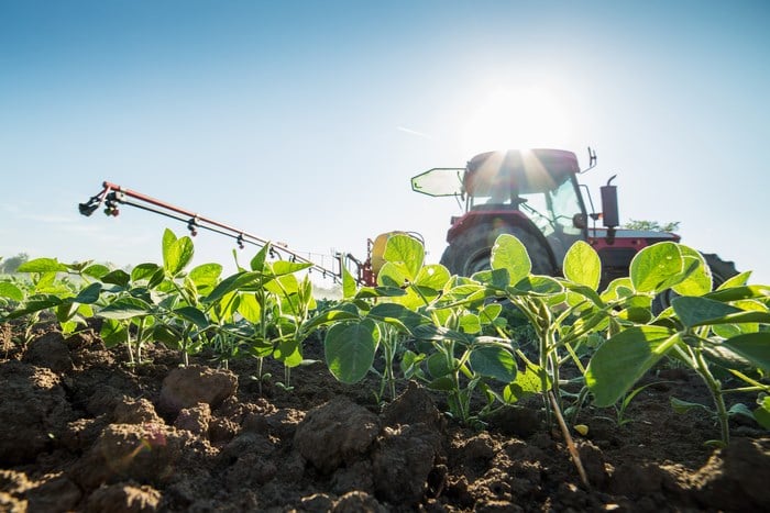 Farmer in tractor on field 