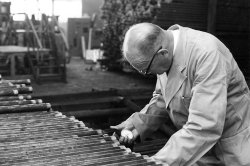 Man performing inspection on items back in the day in black and white