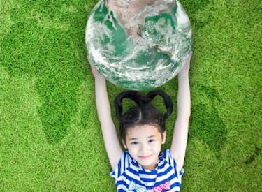 A little girl holding a world globe.