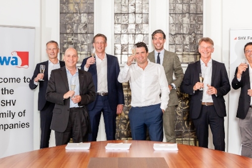 SHV and Kiwa representatives holding up a glass of champagne to celebrate their collaboration