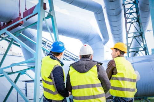 Three Kiwa auditors inspecting oil pipe lines